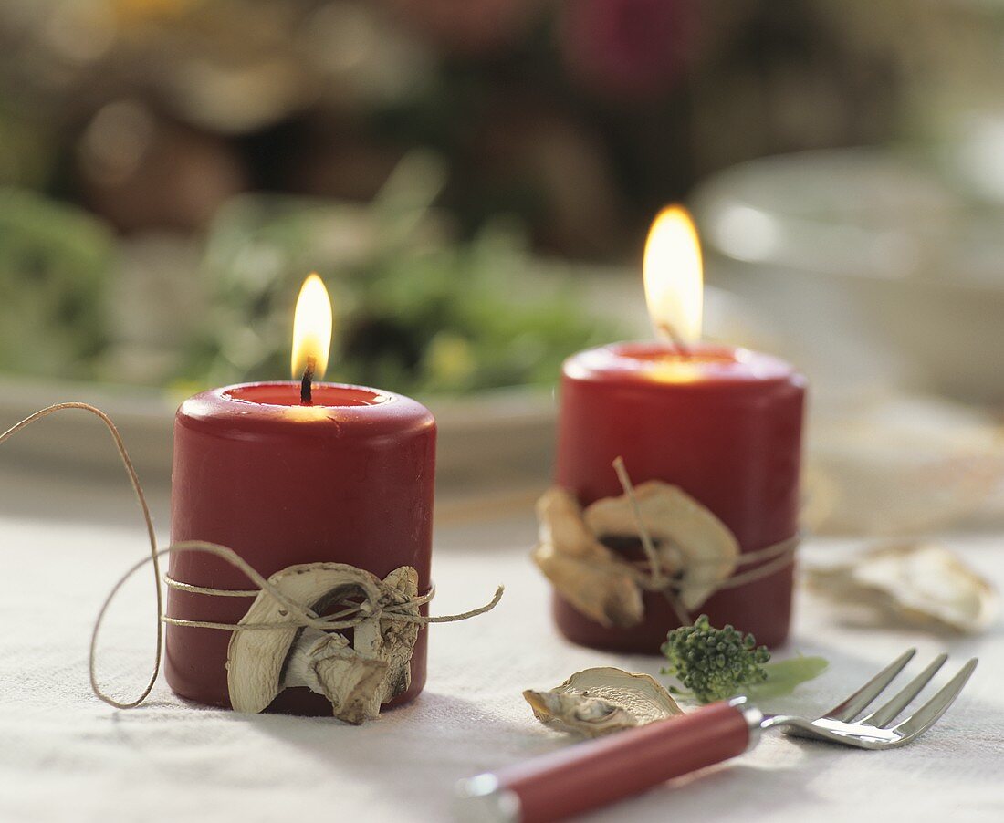 Candles with dried mushrooms tied on with string