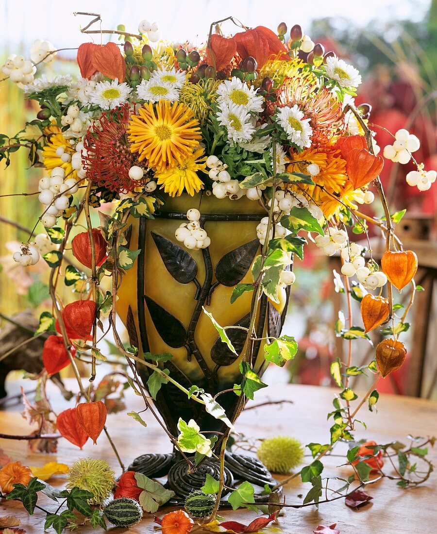 Glass vase of chrysanthemums, Chinese lanterns and Hypericum