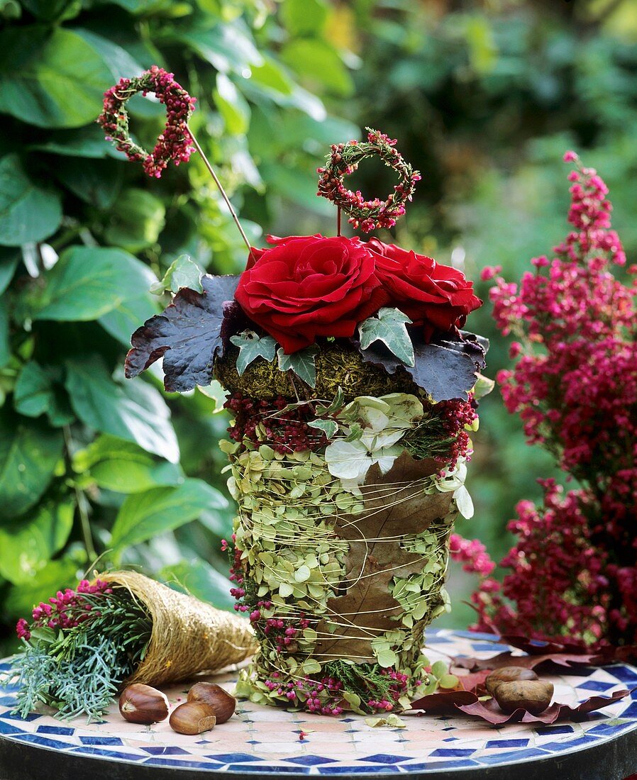 Pot wrapped in hydrangeas, Erica & autumn leaves, moss wreath