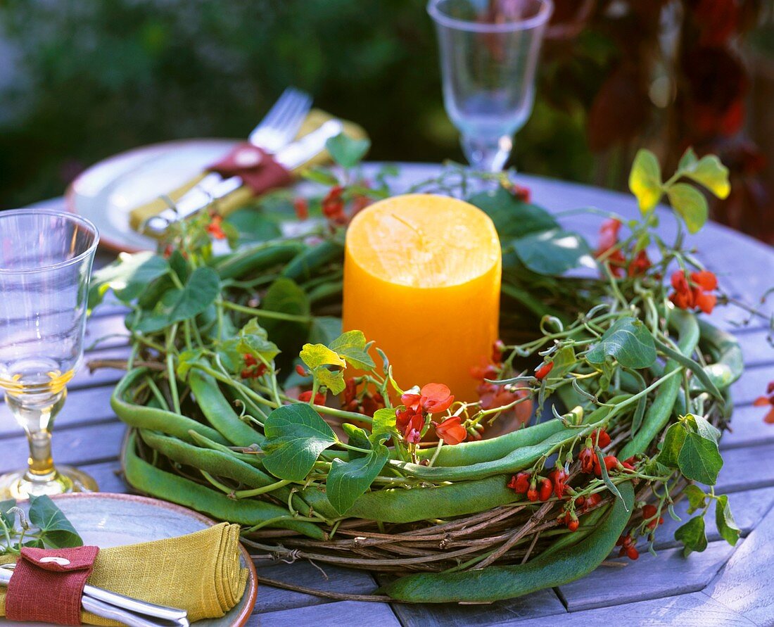 Table wreath of bean tendrils (Phaseolus) and candle