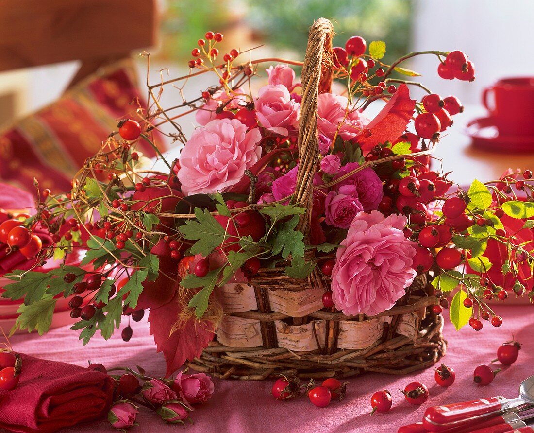 Basket of roses, rose hips, hawthorn and Boston ivy