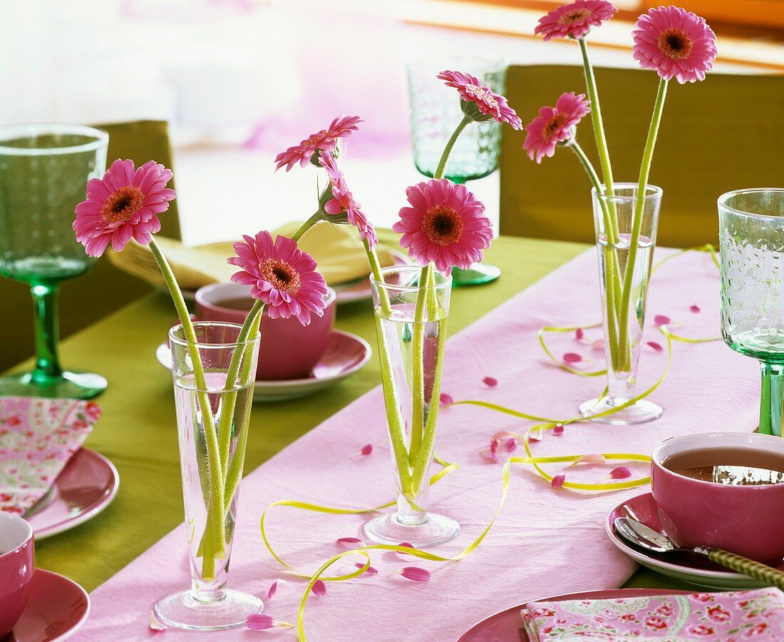 Gerberas in glasses as table decorations