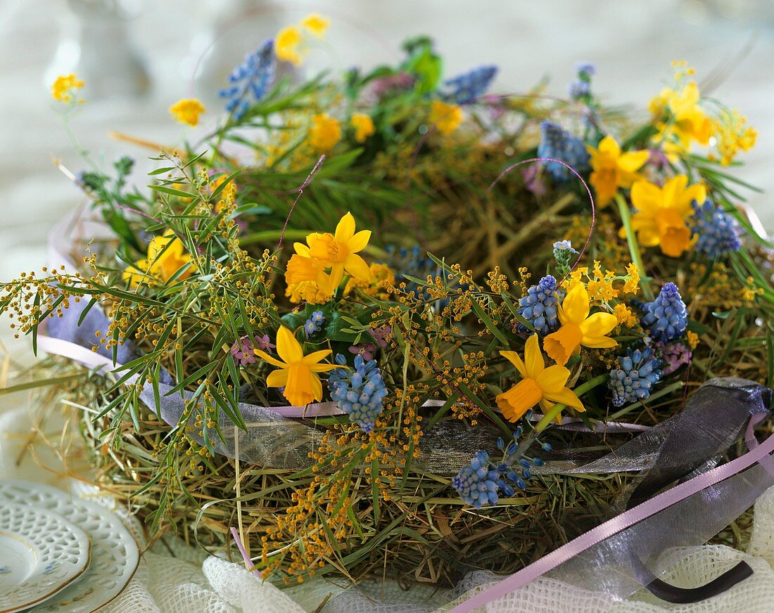 Wreath of hay, daffodils, grape hyacinths and Mimosa