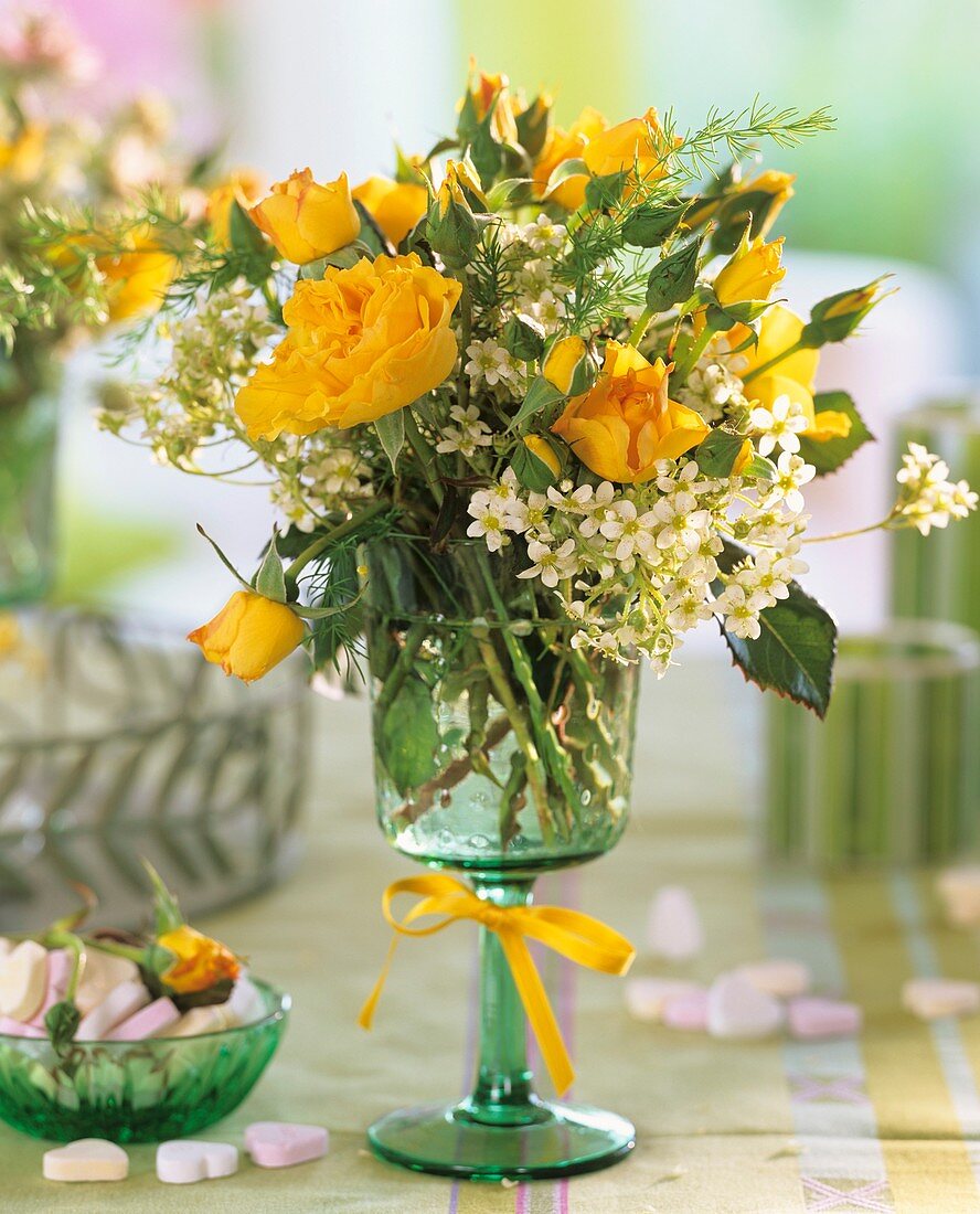 Arrangement of yellow roses and corn spurry, sugar hearts