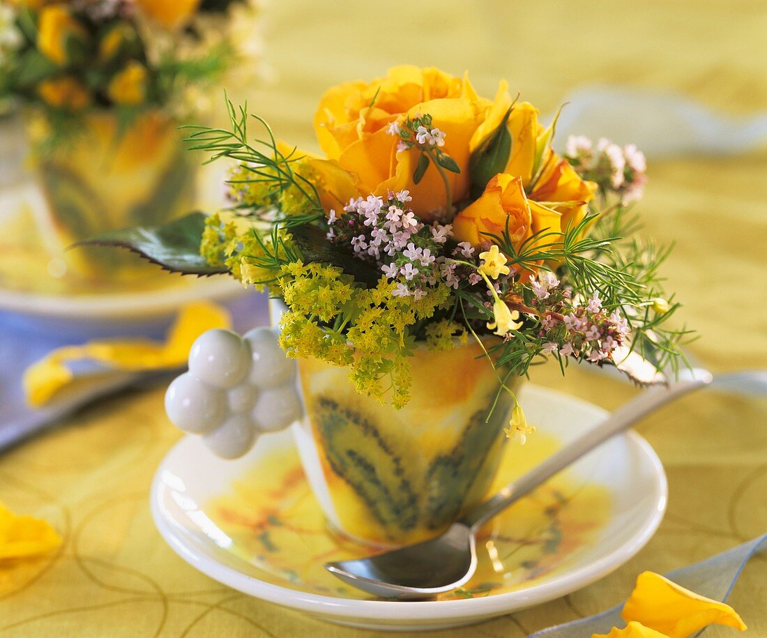 Cup with yellow roses, lady's mantle and thyme