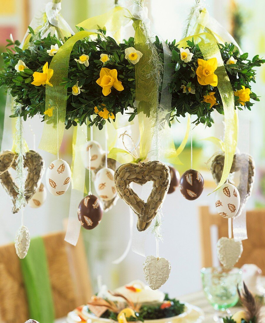Easter hanging wreath with narcissi, hearts, painted eggs
