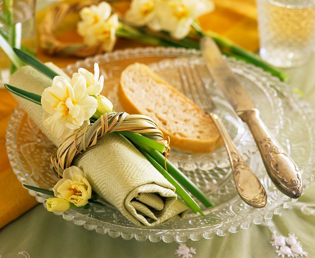 Place setting with narcissi & slice of bread