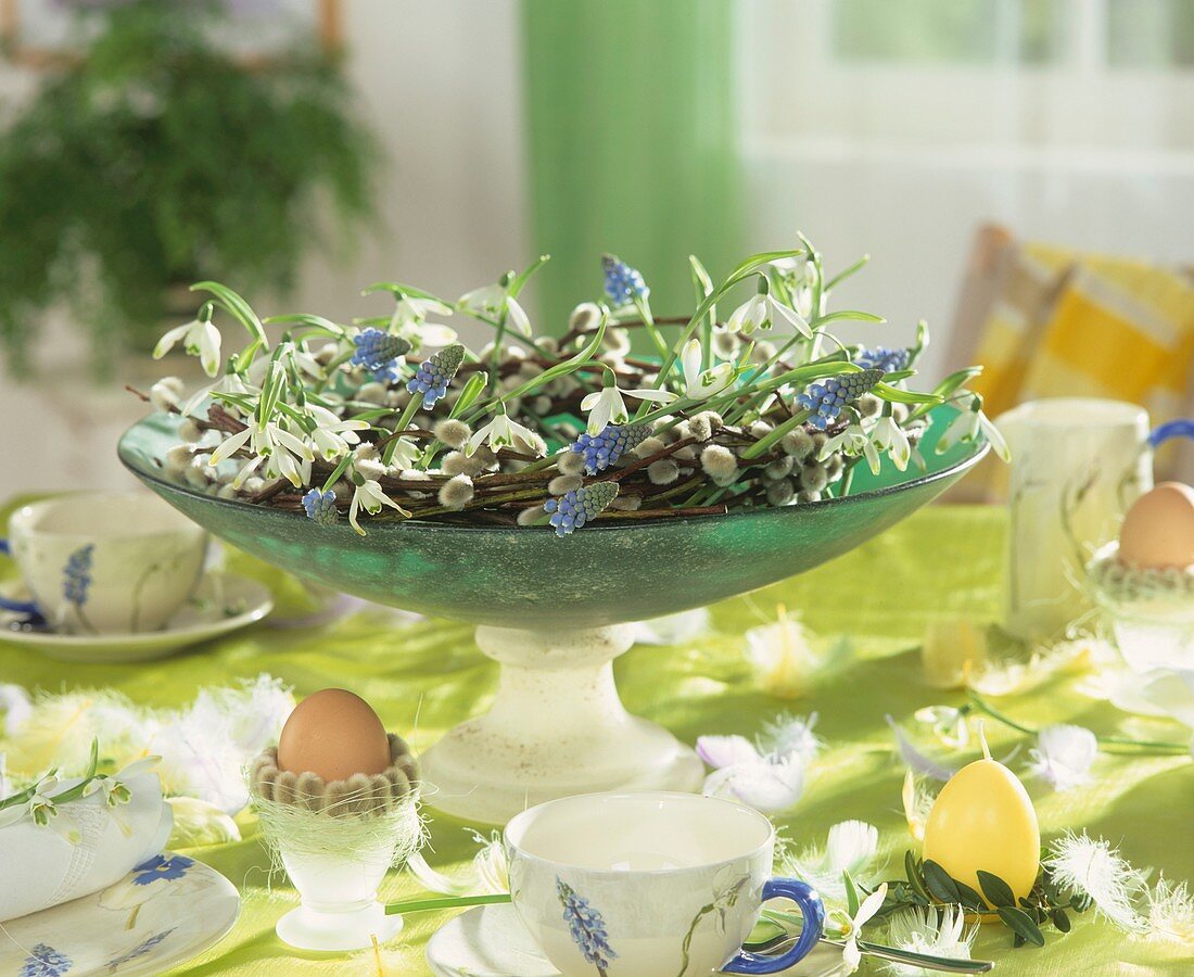 Breakfast table decorated for Easter with willow wreath