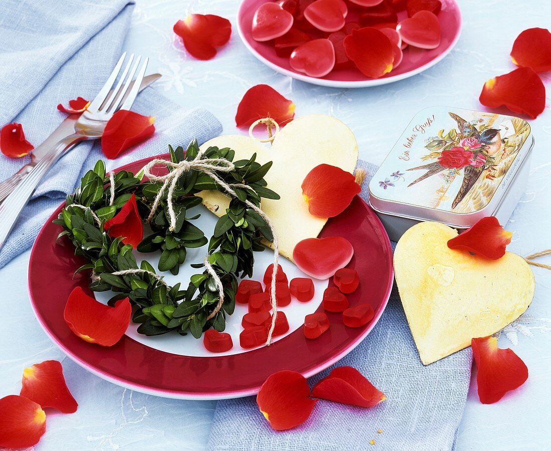 Place-setting decorated with hearts and rose petals