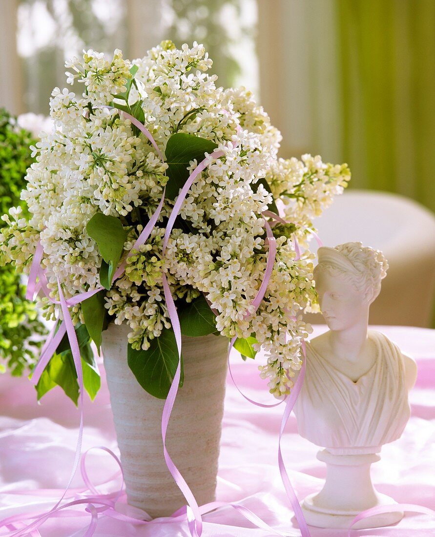 Vase of white lilac and female bust