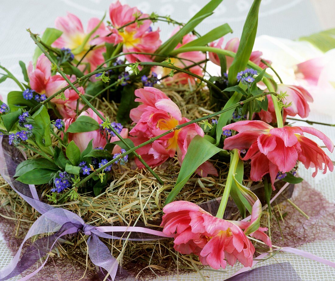 Straw wreath with tulips and forget-me-nots
