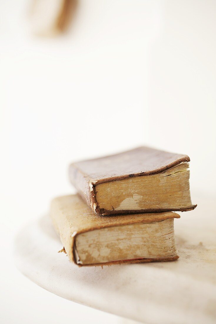 Two old books on a marble slab