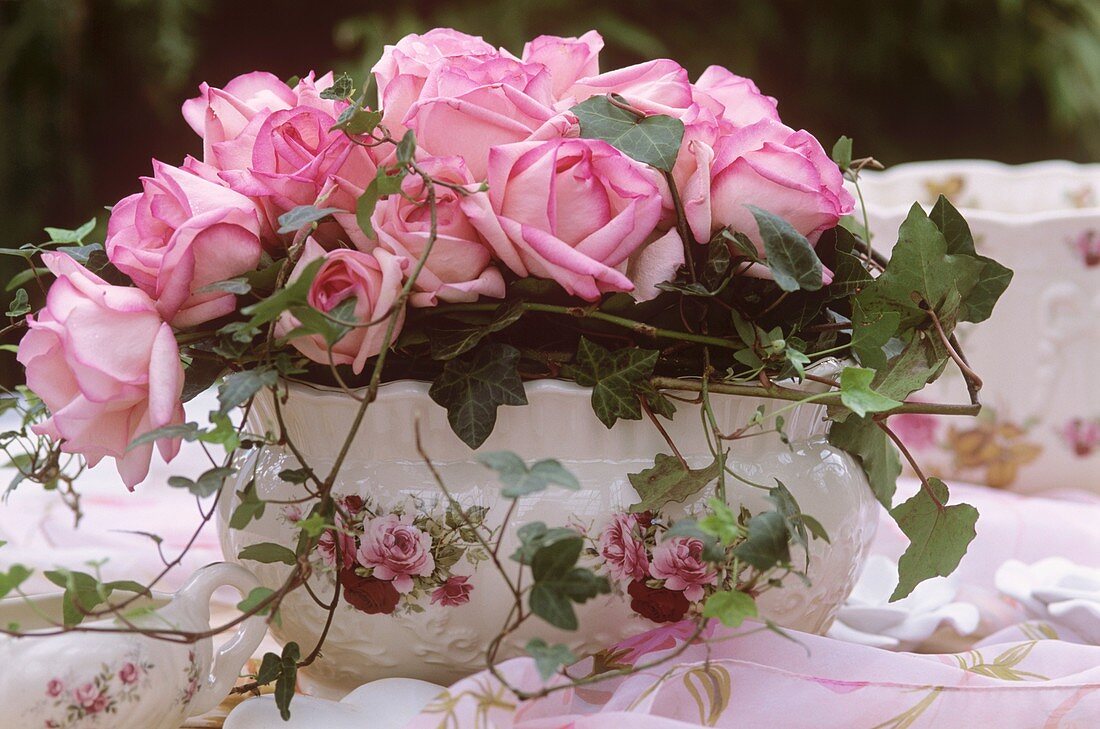 Romantische Jardiniere mit Rosengesteck und Efeuranken