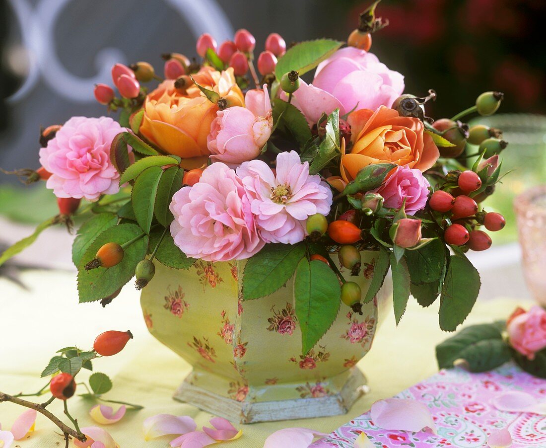 An arrangement of roses and Hypericum berries