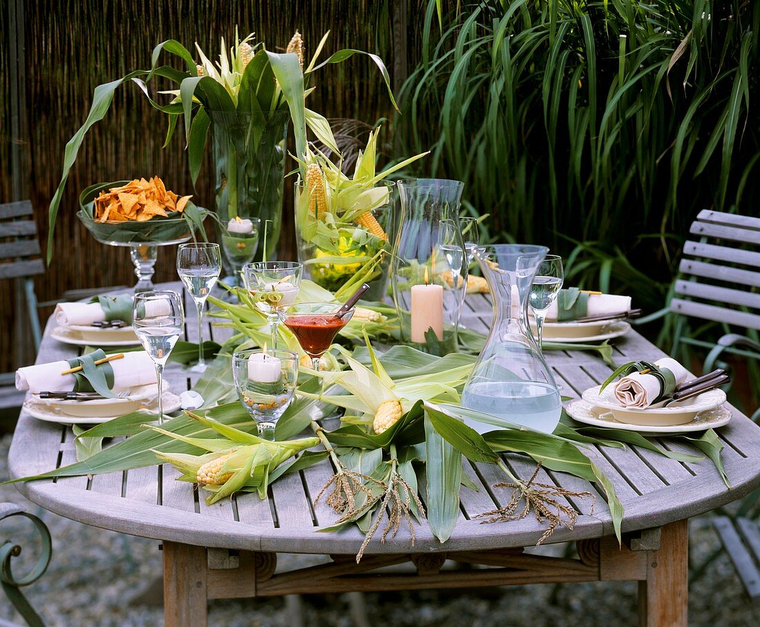 Autumnal table with sweetcorn decoration, taco chips and dip