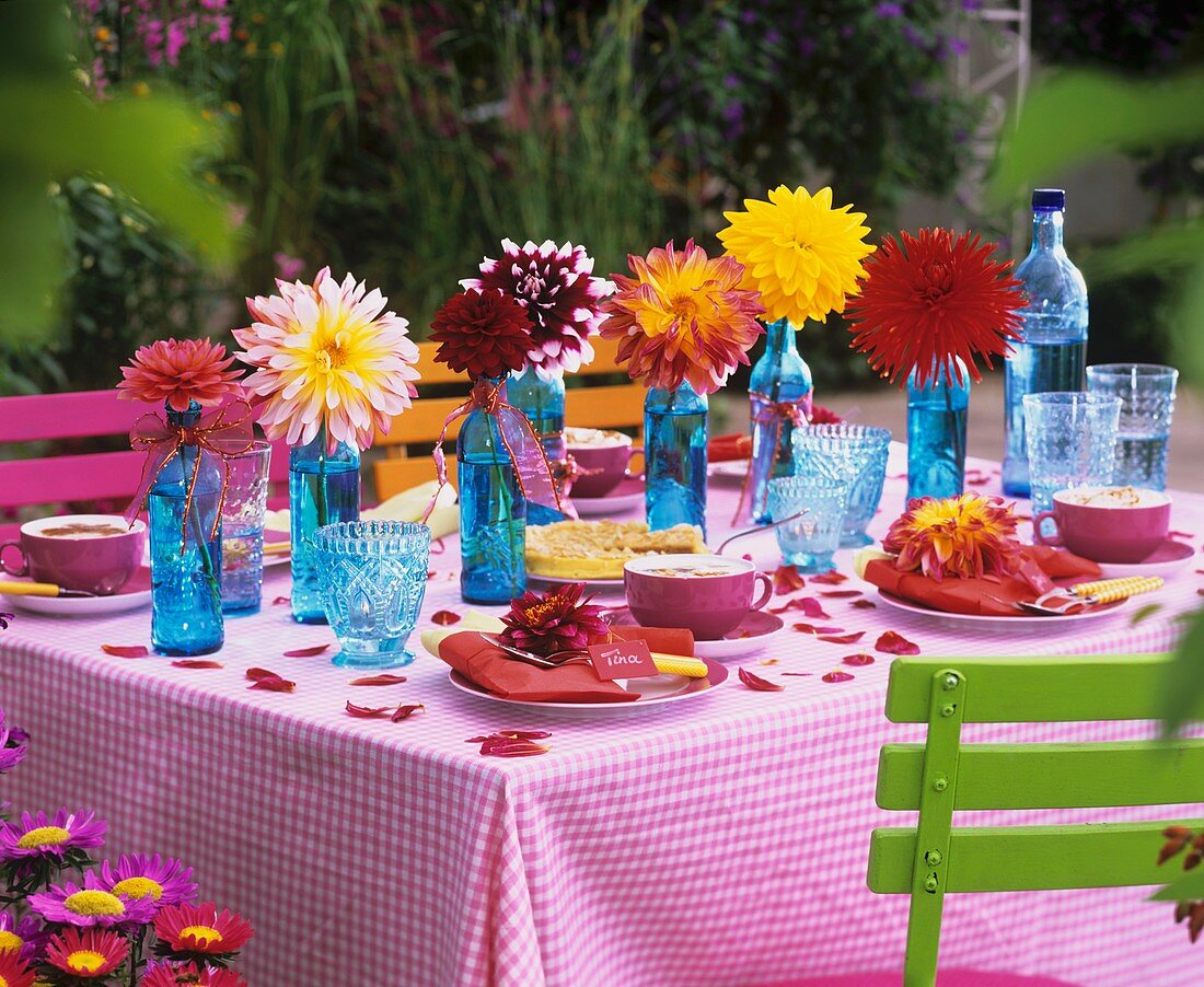 Table laid for coffee with colourful dahlias