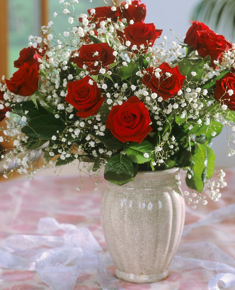 Festive bouquet of red roses and gypsophila