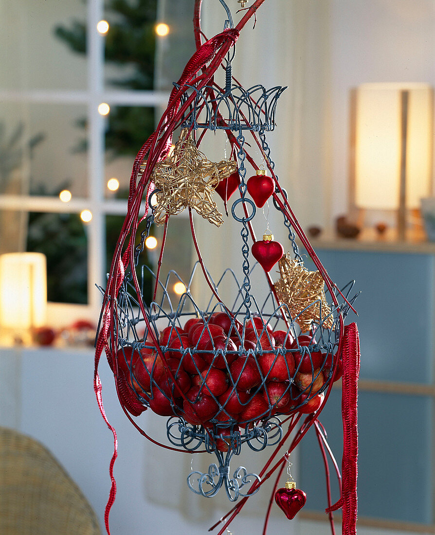 Wire basket decorated for Advent with red apples