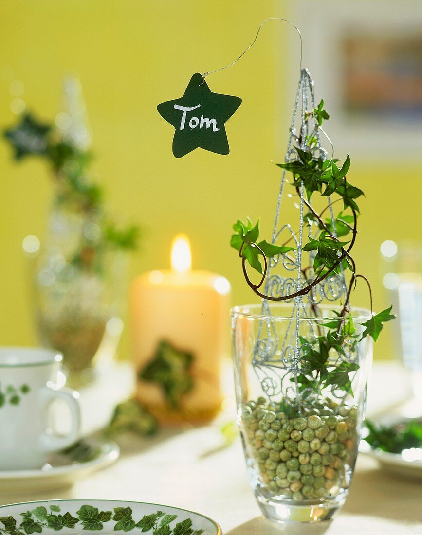 Place-card on decorated glass filled with peas