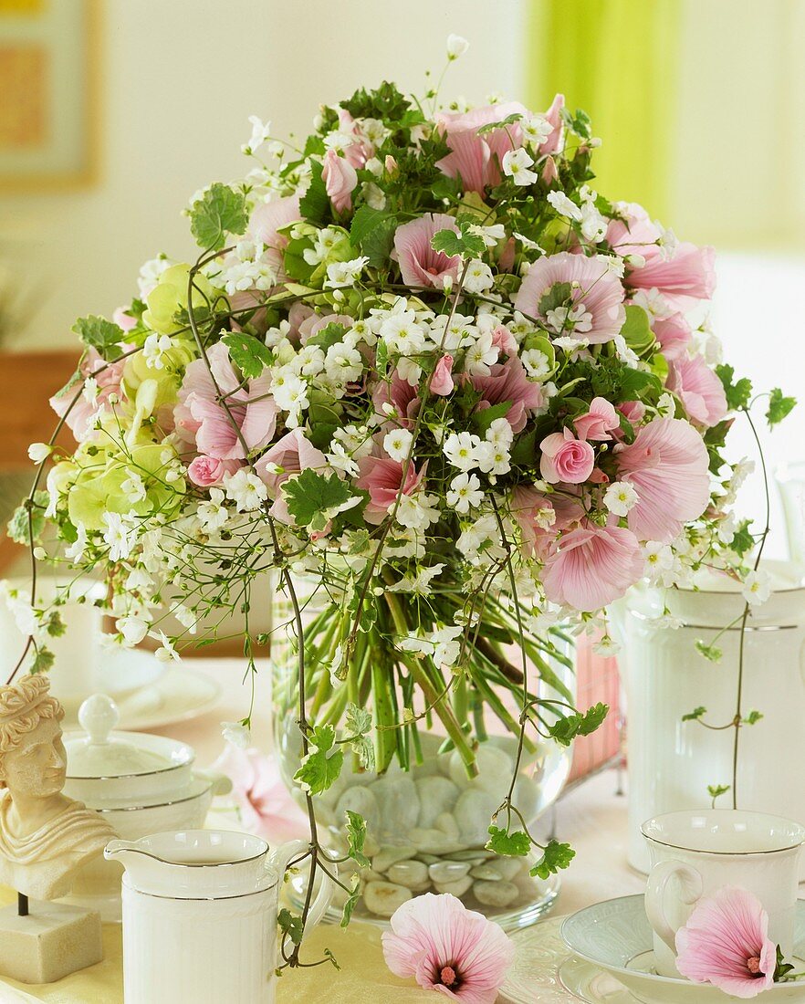 Vase of mallow flowers and gypsophila
