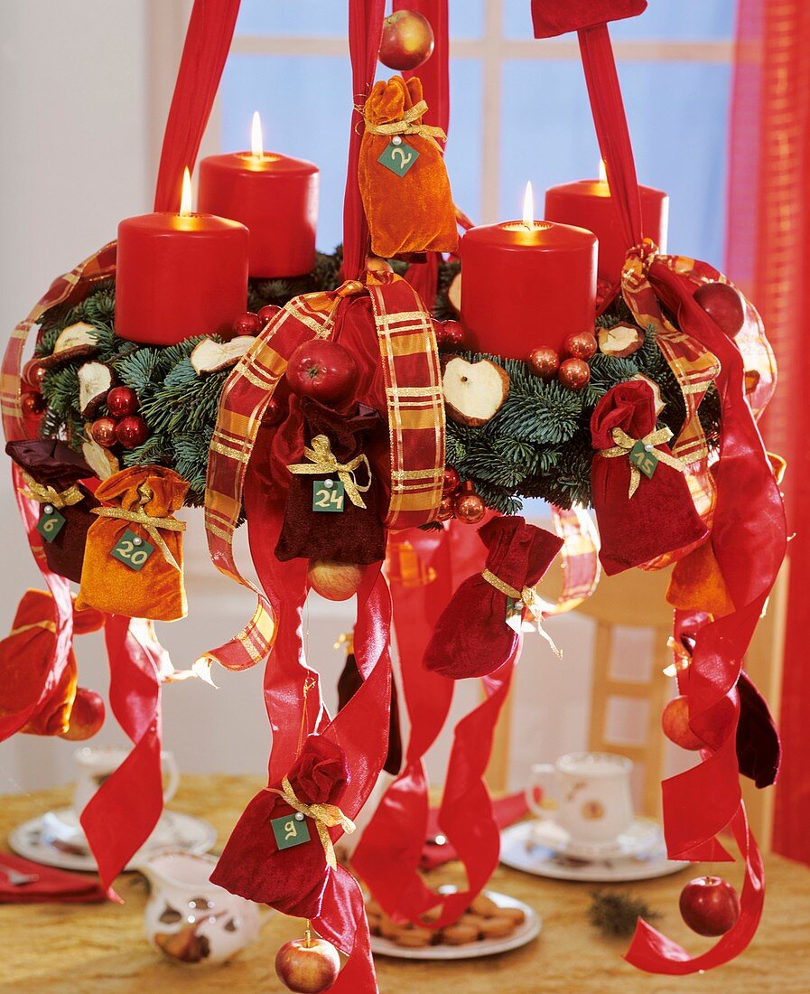 Hanging Advent wreath (Advent calendar) with red ribbons