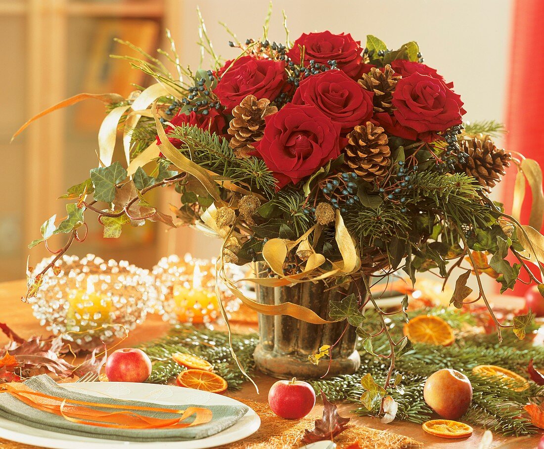 Arrangement of red roses, cones and ivy on Advent table