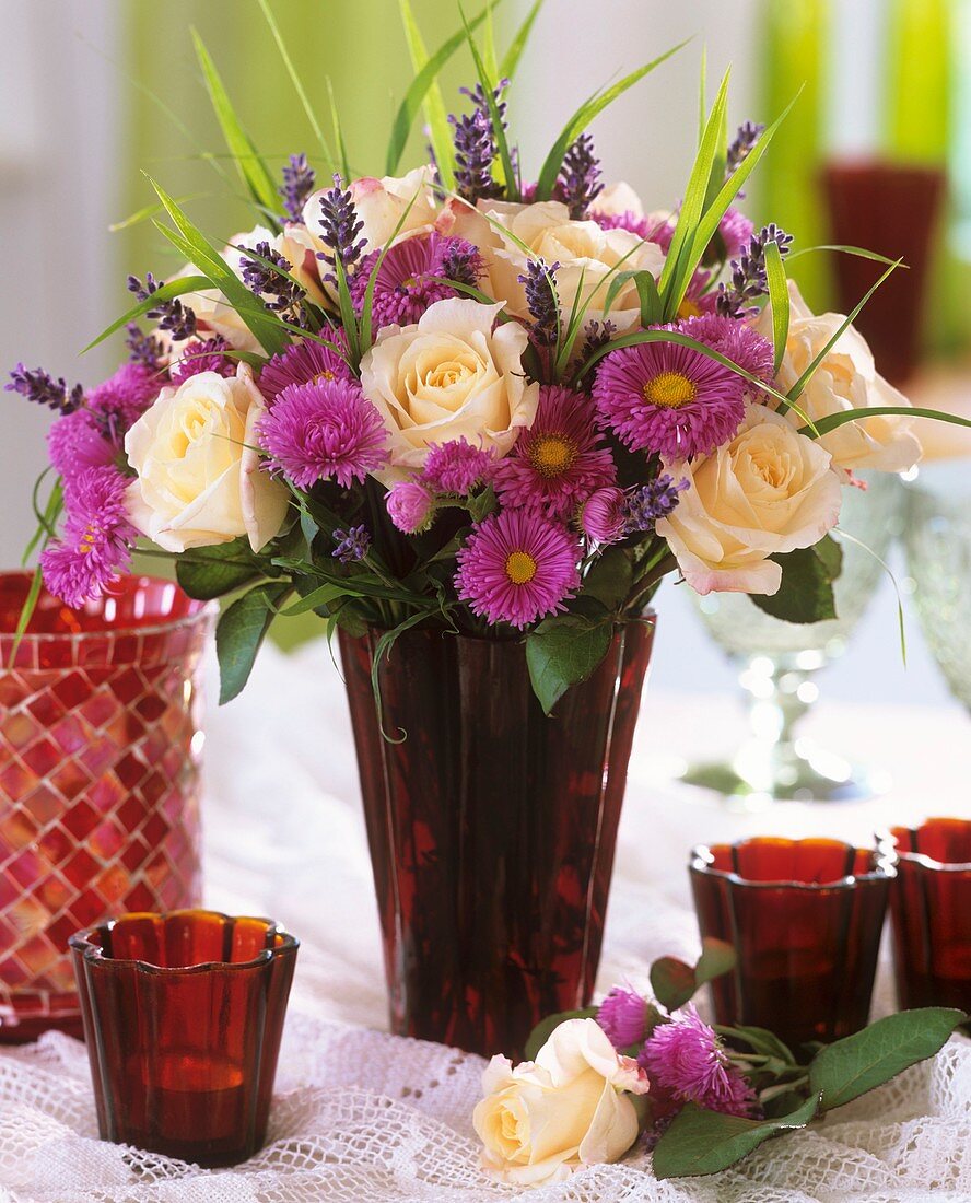 Vase of Michaelmas daisies, lavender and roses