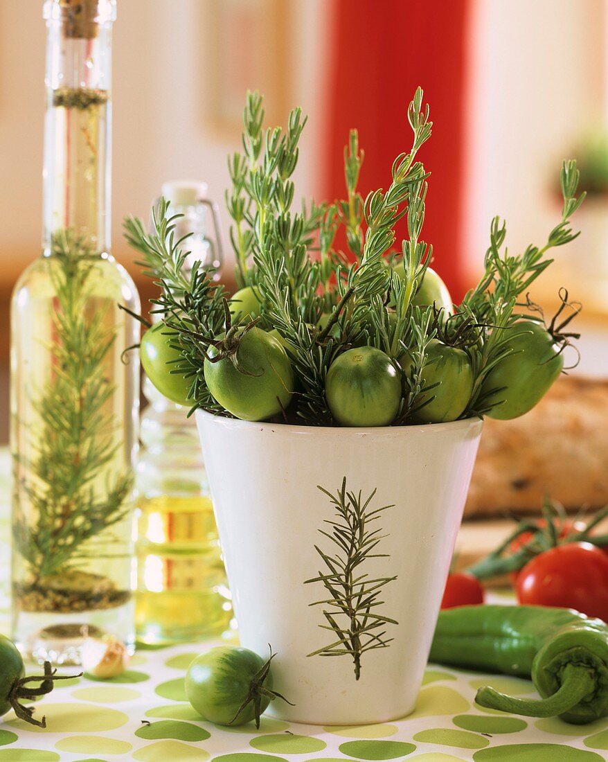 Small arrangement of rosemary and green tomatoes