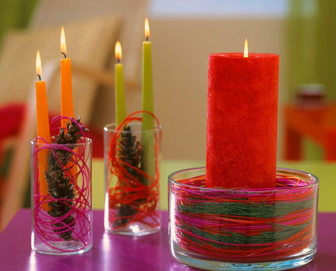 Candles in glasses with coloured cane
