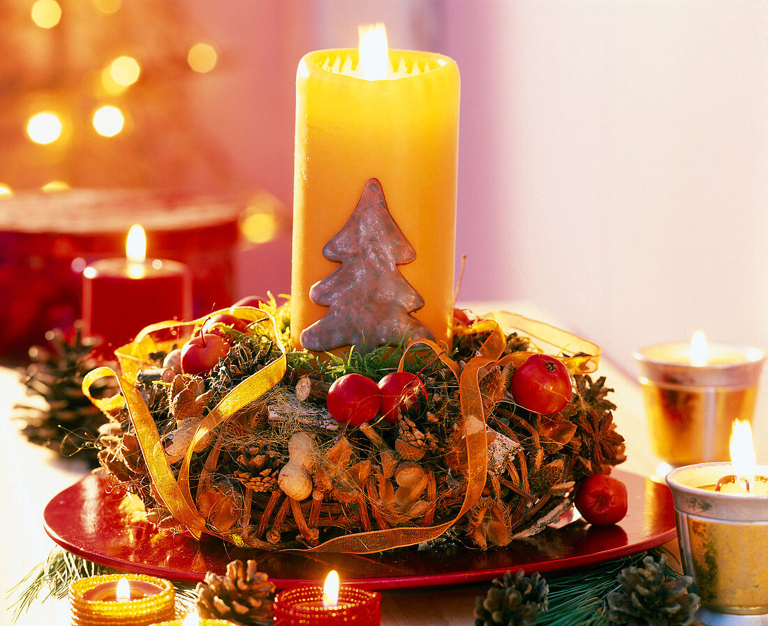 Advent wreath with ornamental apples, nuts and cones