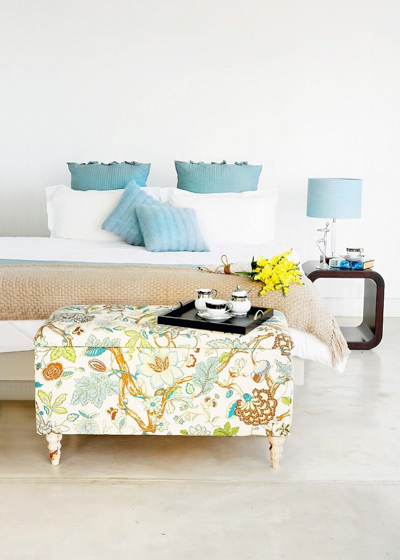 Upholstered, DIY ottoman used as table in classic bedroom