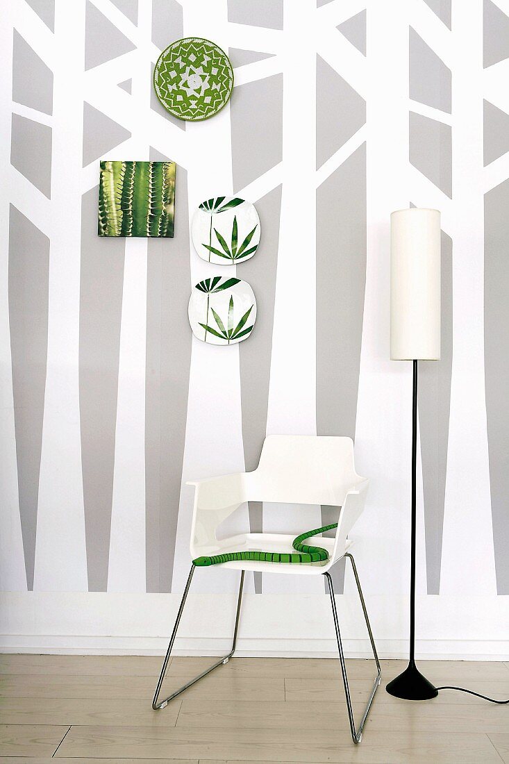 Wallpaper with tree design, chair, standard lamp