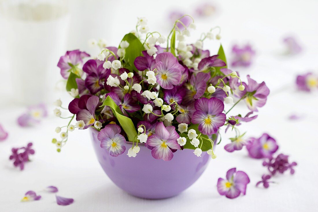 Small bowl of horned violets and lilies-of-the-valley