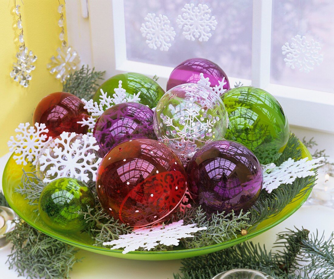 Bowl of transparent Christmas baubles and stars