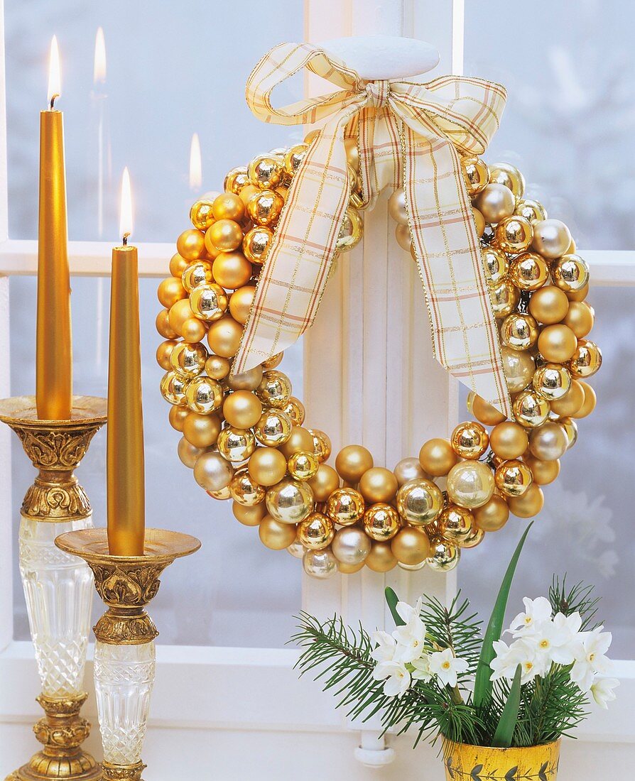 Window wreath of golden Christmas baubles