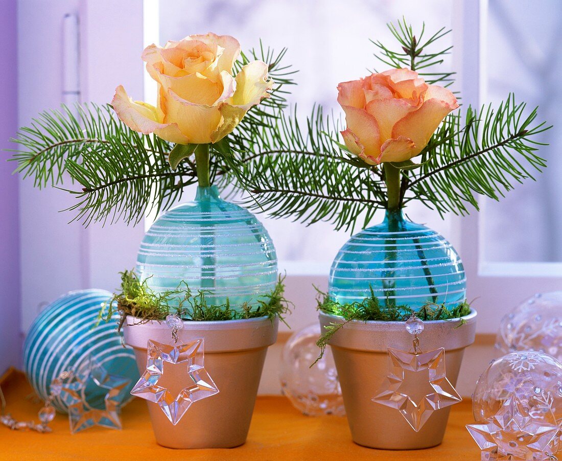 Roses and greenery in turquoise Christmas baubles