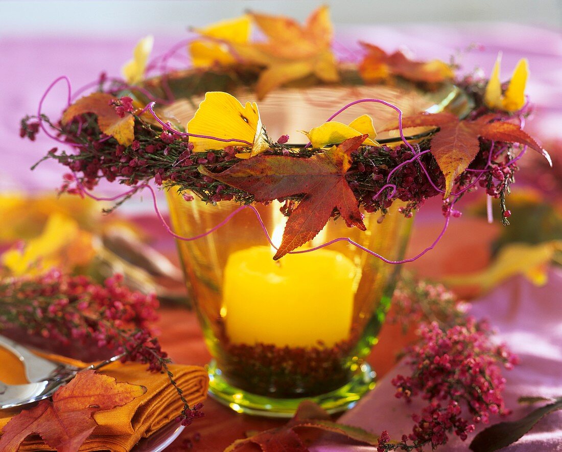 Candle glass with wreath of heather and autumn leaves