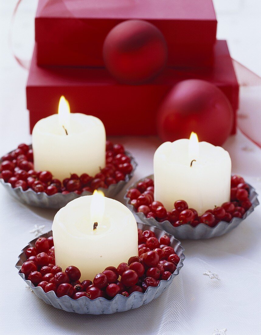 Candles and cranberries in tart tins