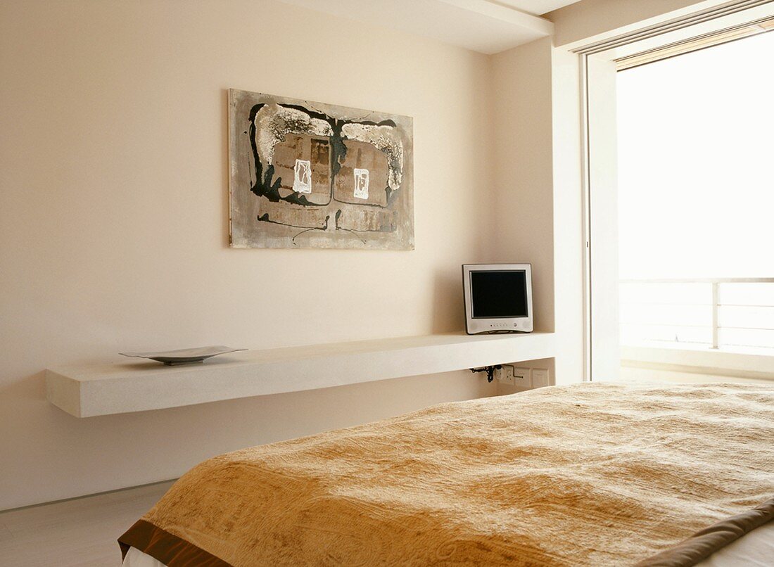 Purist bedroom with large sliding windows and contemporary painting above floating shelf