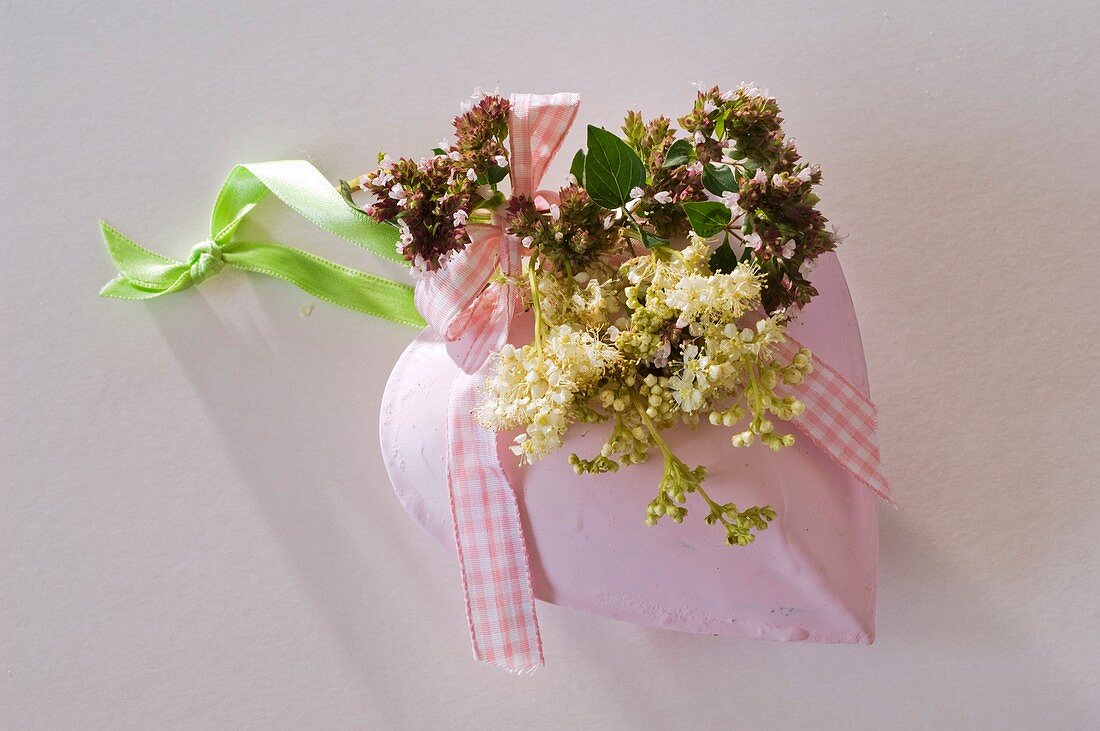Metal heart with oregano flowers and meadowsweet