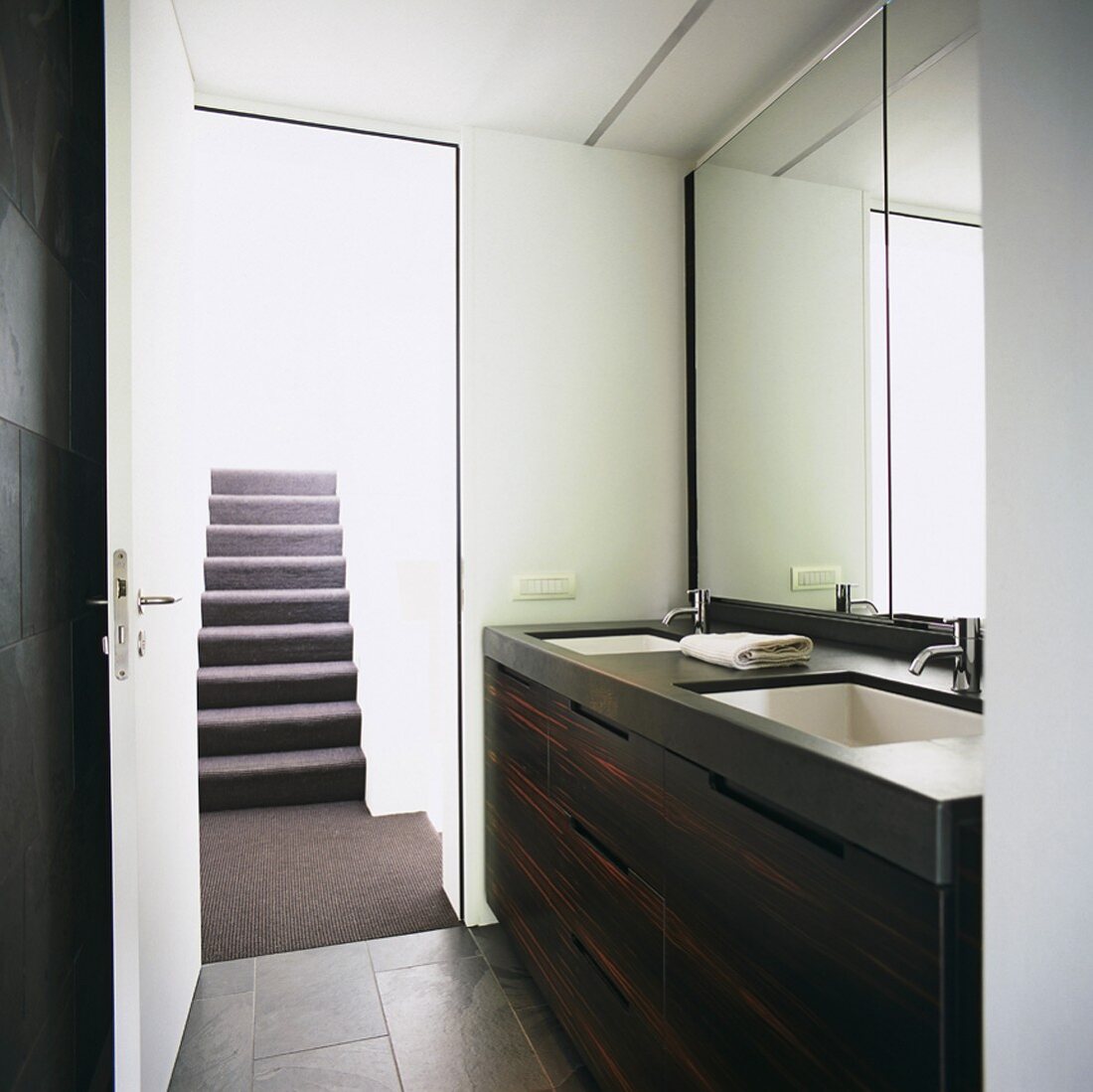 Modern washstand with twin sinks below mirrored wall