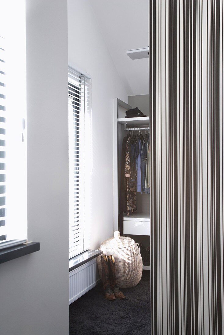 View into dressing room with black and white striped partition