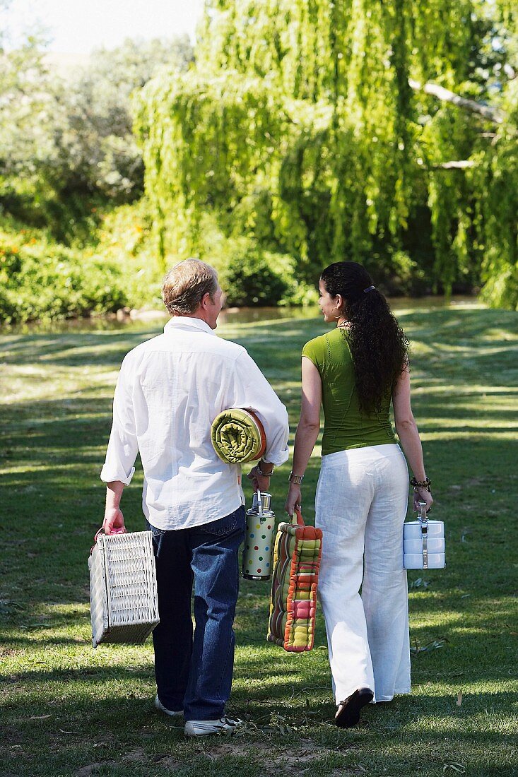 Couple with picnic things in a park