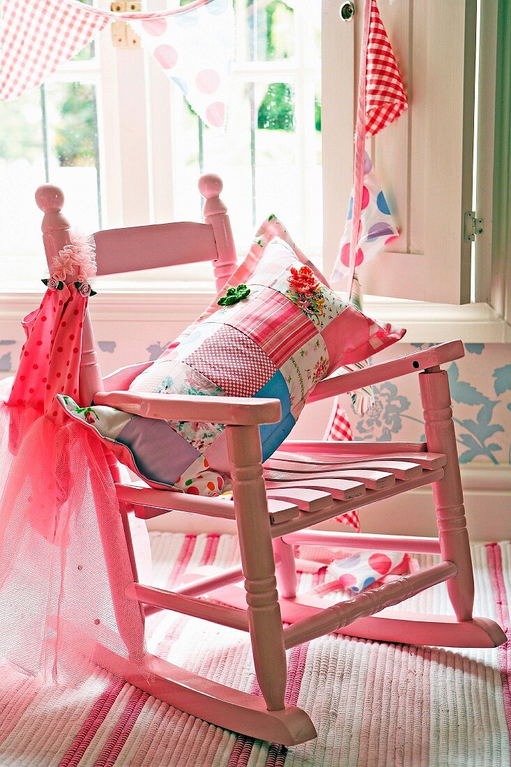 Patchwork cushion on pink, child's rocking chair