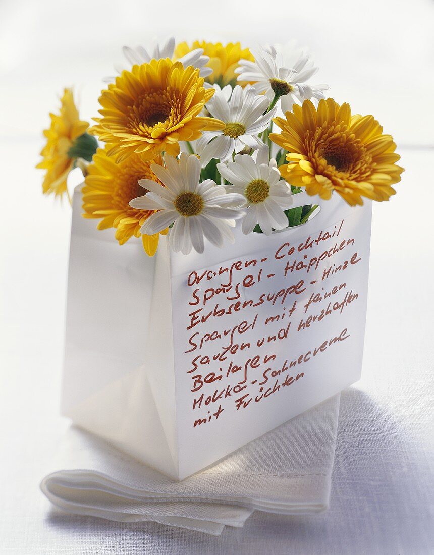 Original menu written on paper bag filled with flowers