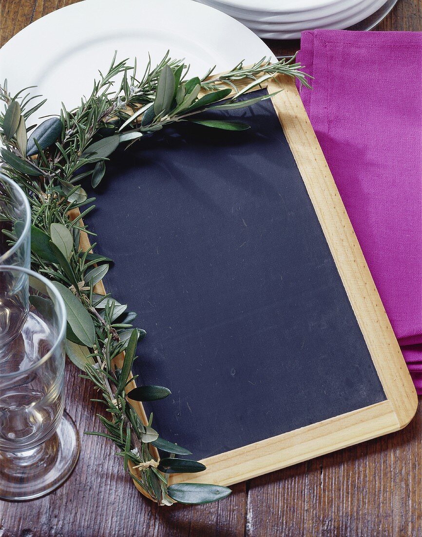 Slate board with herb decoration for writing menu
