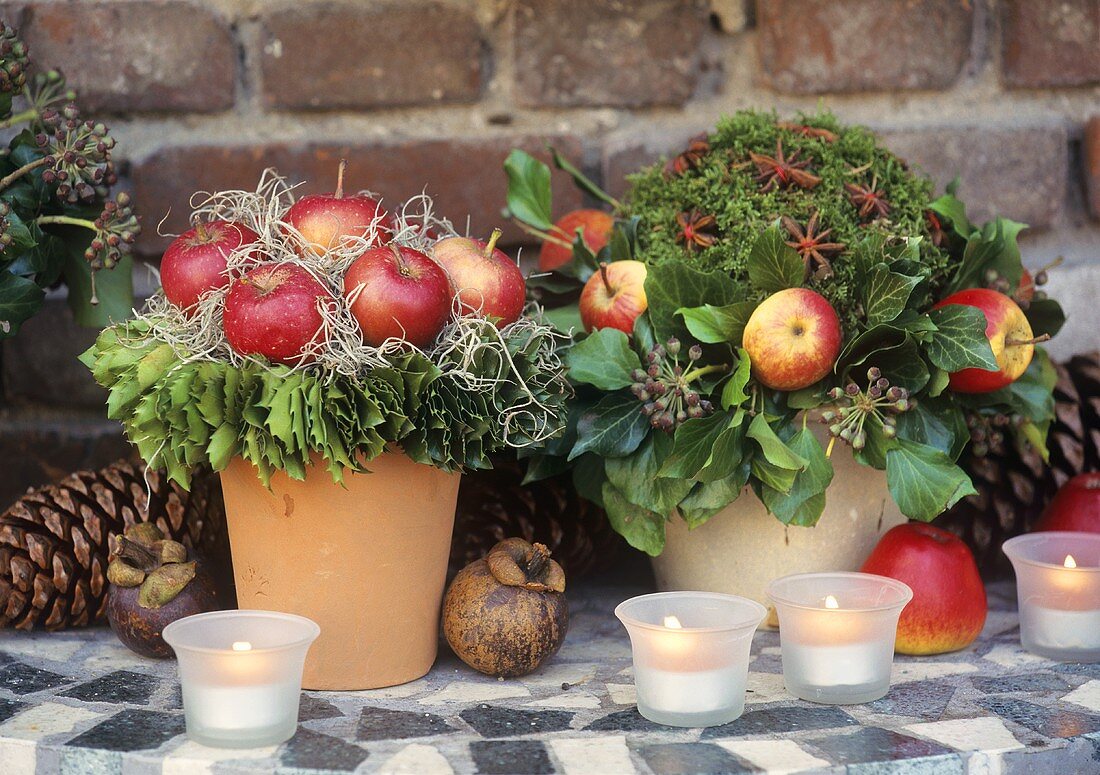 Two wintry arrangements with apples