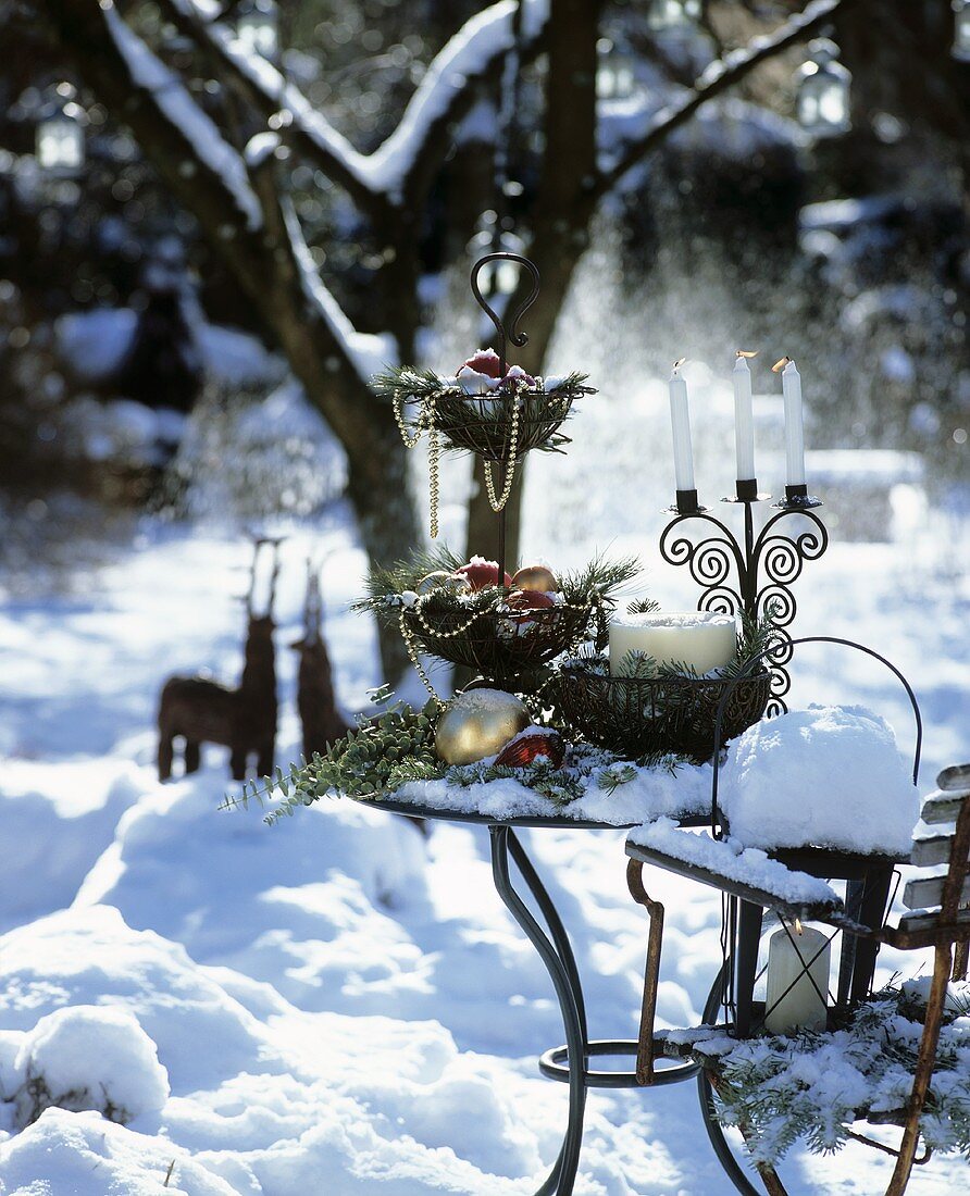 Table decorated for Christmas in snowy garden