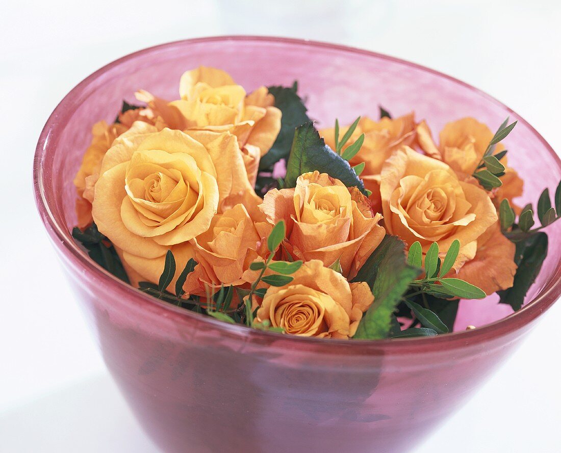 Bouquet of roses & pistachio foliage in a glass bowl