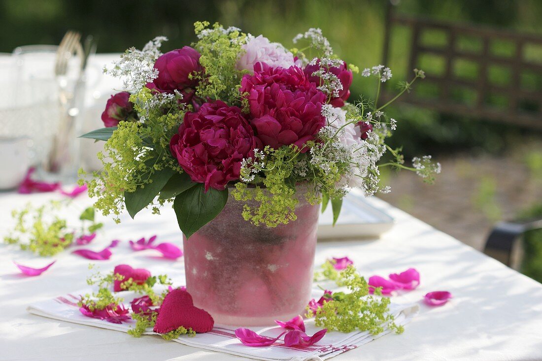 Arrangement of peonies with lady’s mantle and coriander